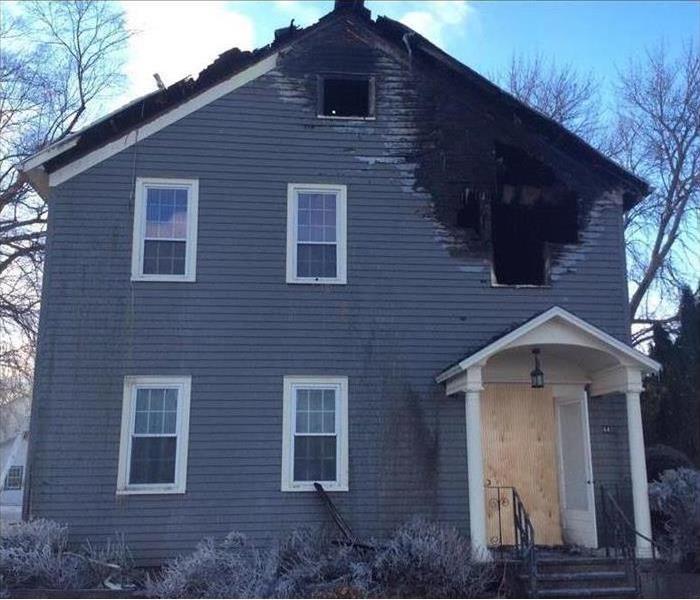 house with fire damage and broken windows