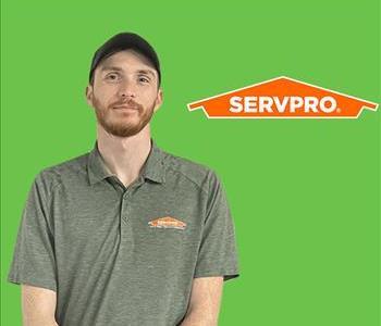 Man in front of SERVPRO Logo on a green screen