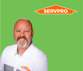 man in front of SERVPRO tools